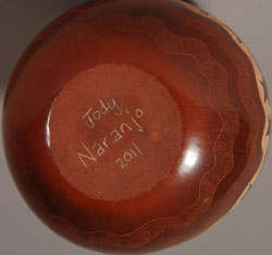 Santa Clara Pueblo Sgraffito Jar with Turtles Jody Naranjo comes from a family of potters and educators. She began making pottery with her grandmother, Rose Naranjo, when she was eight years old. By the time she was a teenager she was creating prize-winning works of art. Jody is an artist who weaves tradition and innovation in a most delightful way. This little jar is a perfect example of her artistic talent. It incorporates the traditional method of hand coiling native clay and hand burnishing with a unique method of sgraffito to create a family of turtles swimming around the side. The jar is signed and dated 2011 on the bottom. Condition: This jar is new and in original excellent condition Recommended Reading: Pueblo Indian Pottery 750 Artist Biographies by Gregory Schaaf Provenance: from the artist