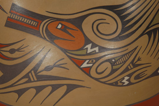 Margaret (b.1936) and Luther (1911-1987) were the children of Lela and Van Gutierrez. Working together, the siblings continued the polychrome style of painting begun by their parents. No other potter at Santa Clara used the mixture of natural colors in their pottery. Colors ranging from tan, red, green, blue, gold, black and white used in this wedding vessel were all obtained from natural pigments.  The wedding vessel is decorated with a very colorful Avanyu (Water Serpent) completely wrapped around the body.  On each neck spout there are pairs of hunter-like figures back to back.  They each have square heads and each carries a spear.  Condition:  The wedding vessel is in original condition  Provenance:  Kathryn Rust collection  Recommended Reading:  Fourteen Families in Pueblo Pottery by Rick Dillingham 