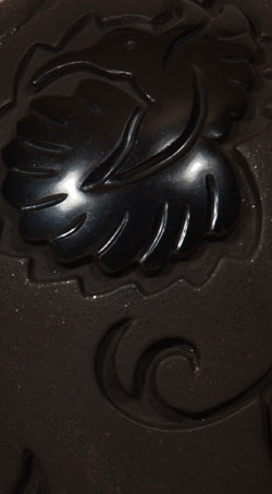 Linda Tafoya Sanchez is known to some collectors by a previous married name Linda Tafoya Oyenque.  She is a daughter of Lee and Betty Tafoya and a granddaughter of Margaret Tafoya.  She credits her aunt Mary Ester Archuleta for training her to be a potter. Linda has branched out from creating traditional burnished blackware with simple carved designs to express her creative talent in design.  She mixes burnished black with matte black and has introduced use of micaceous clay in the mixture.  In this exquisite jar, Tafoya-Sanchez presents highly burnished butterflies, hummingbirds, and dragonflies backed by matte micaceous clay.  The combination of burnish and matte finishes resulted in a jar of striking visual appeal.  Provenance: From the artist  Condition: The jar is in original condition. 