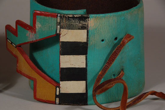 This wonderful pair of armbands was made for and was used in a pueblo dance ceremony.  They are made of thick saddle leather and the overlapping ends carved in kiva-step form.  They were beautifully painted in multi colors, the primary one being turquoise.  Condition:  Original excellent condition with minor paint loss due to use. 