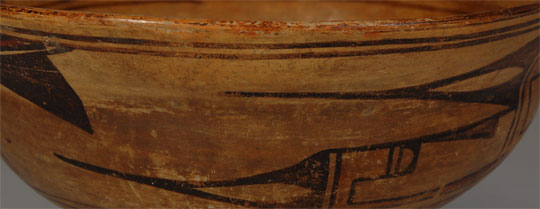 Old Hopi pottery takes on the most luscious look after years of use in daily household chores.  This bowl certainly was lovingly used for decades.  The interior slip on the bowl is worn thin and has assumed a soft oily look.  The rim design is still intact as is the exterior design—a design that was borrowed from the Zuni.    The deep red slip on the underbody has practically worn away from the years of the bowl being rotated while in use.  The warm orange glow of Hopi pottery is a result of the firing technique and all Hopi pottery fired in that manner has warmth to it but, after decades of use, it takes on a particularly exciting luster that only comes from use.  Take a look at the images and see if you have the reaction I had.  Condition:  normal wear from use Provenance: from an Albuquerque gentleman 