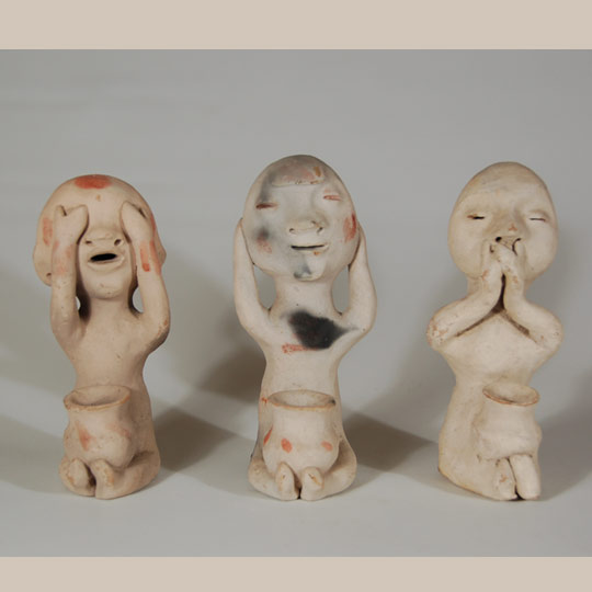 According to Duane Anderson, author of When Rain Gods Reigned: From Curios to Art at Tesuque Pueblo, sets of 3 rain god figurines based on the Chinese-influenced "see, hear, speak no evil" form appeared between 1900 and 1925.  Less than a dozen sets were found and examined by Anderson during his period of research and only a fourth of them had pots on their laps.  He found the earliest set located in the collection at the Heard Museum in Phoenix.  That set was reportedly found wrapped in a 1907 newspaper.  Anderson speculates that most of this style was made between 1900 and 1910.   This set, from the Rosenak collection, appears to have been made by different potters as the facial features are different.  This is not unusual in that most of the figurines were sold as individual items rather than as complete sets.  Collectors have sometimes spent years finding all three to complete a set.  This set also features pots in the laps of all three figurines.  The "see, hear, speak no evil" sets with pottery jars in their laps are the rarest of the style.   Condition:  original condition Provenance: from the collection of Chuck and Jan Rosenak, renowned collectors and authors of Navajo folk art.  Recommended Reading: When Rain Gods Reigned: From Curios to Art at Tesuque Pueblo by Duane Anderson