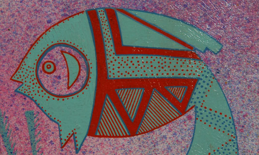 Over a sprayed background of mixed colors, Hardin fashioned a beautiful green fish with exquisite body designs of red triangles and polka dots.  The triangles are filled with red parallel lines and the polka dots are in red and blue and laid on the body in architectural precision in the Pueblo tradition.