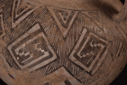 Close up view of this Prehistoric Black on White Pottery Jar with Handle