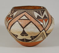 Designs on pueblo pottery were influenced by many outside sources starting as early at the mid-1800s. Floral elements, birds, deer, and other designs could easily have been influenced by Spanish colcha designs as well as pottery designs from Mexico. It was also evident that potters borrowed designs from pueblos other than their own.   The heartline deer design was first seen at Zuni Pueblo, but later appeared on pottery from Acoma, Laguna and Zia Pueblos. Intermarriage between pueblos also contributed to designs appearing where they never appeared before.   This Acoma jar is completely covered with Zuni design elements. The orange/red fine lines in the A-frame areas are most typically Zuni in origin. The entire layout of the design is typical of Zuni arrangement, yet the pot is from Acoma Pueblo. It is not as thin-walled as Acoma pottery generally is so it is possible that a transplant potter from Zuni or another pueblo moved to Acoma and practiced the art of making Acoma pottery but had not yet achieved the expertise of creating thin walls.   The jar is a beautiful example of a well formed vessel and a beautifully arranged design. It is in excellent condition.