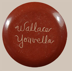 Wallace Youvella is the son of famous Hopi potter Susie Youvella, however, he did not learn the techniques of making pottery from his mom, but learned by watching his famous wife Iris Nampeyo as she worked.  Early examples of Wallace’s pottery is more in the style of red-slipped, stone-polished wares from Santa Clara Pueblo, then later he switched to the more traditional Hopi style.  This small seed jar is slipped with red clay on the rim and lower body and includes sgraffito designs of Kokopelli playing his flute around the corn plants on the upper shoulder.  I recall purchasing this style pottery from Wallace in the early 1980s so I would speculate that this one dates to that period.  Condition: The seed jar is in original excellent condition.  It is signed by the artist.  Provenance: ex.coll. Tulsa, OK pottery collectors 