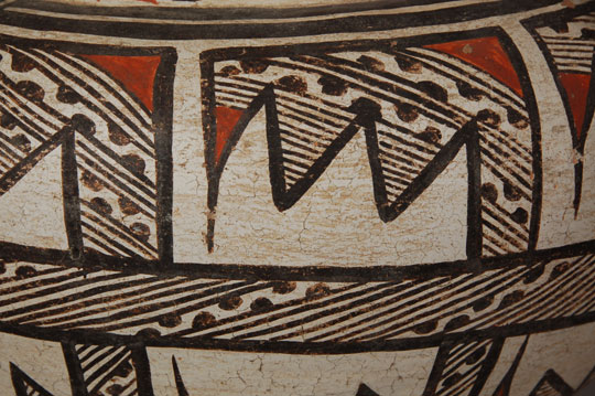 According to Lanmon and Harlow in The Pottery of Zuni Pueblo, there are several factors that can be used to date Zuni Polychrome pottery.  These factors have been gleaned from the enormous collections of pottery by the BAE from Zuni Pueblo in the periods 1879 and 1885 and from the collections by the American Museum of Natural History between 1889 and 1912.  Some of the factors are vessel form, interior neck paint, underbody paint, and design changes.  During the Kiapkwa Polychrome period (which preceded the Zuni Polychrome period), vessel shapes appeared globular with a high shoulder rolling over and rising to a short neck.  This Zuni jar has a shape similar to late Kiapkwa Polychrome jars but is of later manufacture based on other criteria.  The interior of the neck is painted in a wide brown slip, indicative of the Zuni Polychrome period, and the underbody is painted brown.  Indications are that this jar dates to the late 1800s.  The neck band decoration is quite similar to one in the referenced book that is dated 1870-1880 by the authors.  The body is composed almost entirely of hachured designs, executed in brown and red and outlined heavily in brown.  Condition:  There are several nicks at the rim, a chip missing on the underside, and some abrasion of the decoration.  These are quite acceptable on a late 19th century jar.  Provenance:  From the collection of an Arizona collector of historic pottery Recommended Reading: The Pottery of Zuni Pueblo by Dwight Lanmon and Francis Harlow 