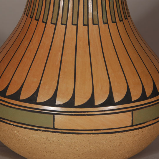 Blue Corn and her husband, Sandy, spent two years in the 1960s experimenting with slips in an effort to revive the 19th century Polychrome wares of San Ildefonso Pueblo. She stone polished the base slip in the manner it was done before introduction of the Cochiti slip in 1905, which required only rag polishing. In doing this, she achieved a highly burnished finish. To this she applied the matte paint designs at which she was so adept.  Blue Corn made redware and blackware during the earlier part of her career and specialized in polychrome wares during the latter part of her career. Most collectors prefer her polychrome wares.  Normally, she applied a creamy white slip as the base coat, but in this jar, it appears she eliminated the slip and stone polished the natural clay.  Over the polished surface, she painted the designs using black and green slips.  The lower part of the vessel, below the design section, is slipped in beige micaceous clay.  This jar is certainly one of her creative ventures that turned out to be successful. Condition:  The jar is in original condition.  There is one minor blister bubble and one very minor pit where probably a grain of sand popped out. Provenance: ex.coll. Minnesota pottery collector Recommended Reading: Pueblo Indian Pottery: 750 Artist Biographies, c.1800-Present 