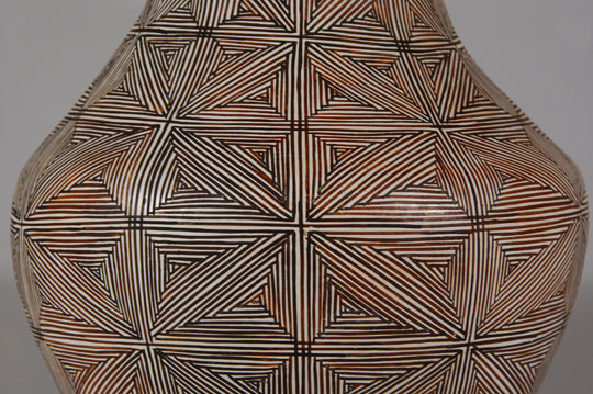 Juana Leno has always been my favorite potter from Acoma Pueblo.  I met her around 1975 and purchased pottery from her until she no longer was making it.  We had a long and friendly relationship.  She was an excellent potter and her painting skills were unequaled.  If one looks at the intricate layout of the design on this wedding vessel, it confounds logic that a potter would even attempt such a complicated design when something simpler would suffice.  That was the way she treated each of the items she made.  Speed was not paramount but quality was.  Condition:  The vessel is in excellent condition.  Provenance: an Albuquerque gentleman  Recommended Reading: Acoma and Laguna Pottery by Rick Dillingham 