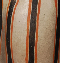 Helen Cordero was truly an original artist. Unable to fashion pottery vessels in a manner with which she could be satisfied, she changed her course to figurative pottery, rather than give up altogether. Little did she know that she was starting a new tradition in pueblo pottery production? She first exhibited her early figurative pottery at a Kewa (Santo Domingo) Pueblo feast day in the early 1960s. Folk art collector, Alexander Girard, bought all the pieces and encouraged her to make more and bring them to him. He encouraged her to add more children and make larger pieces. When thinking this over, she remembered her grandfather and made an image in his honor with a number of children climbing over him. This was the beginning of the storyteller figurine. Cordero also made other figurines. She made female figurines with Hopi hairstyles, turtles with children on their backs, animals, and nacimientos, female figures with pottery on their heads, and female figures with children. Her female figurines with children are called Singing Mothers. She did not make female storytellers. All her storyteller figurines are male. This Singing Mother is from the early 1970s and is exquisite. The one child in her arms is an infant. In Cordero fashion, the adult female has her eyes closed and her mouth open. She is wearing an exquisite traditional woven belt. Her dress has an embroidered design at the hem. She wears traditional pueblo moccasins and her head is draped with a shawl. Singing Mothers are significantly rarer than Storytellers because Cordero made so few of them compared with the larger number of storytellers. Condition:  The figurine is in excellent condition.   Provenance: From the collection of a Santa Fe resident.  Recommended Reading:  The Pueblo Storyteller by Barbara Babcock 