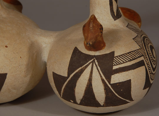 This is a wonderful and charming canteen that is comprised of two chambers and a strap handle that serves as the spout.  Each of the chambers is a complete rooster figure.  The canteen is signed with the initials JCP which we have determined are those of Juana Concho Pasqual, who has been listed in Schaaf as an active potter from the 1920s to 1990+ and that she lived in the Acoma village of San Fidel, NM.  Condition: The canteen appears to be in excellent condition.  Provenance: from the collection of Kathryn H. Rust  Recommended Reading:  Southern Pueblo Pottery 2000 Artist Biographies by Gregory Schaaf 