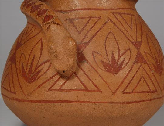 Native Americans of all tribes have a deep respect for snakes and reptiles in general and it is not unusual for them to use them in some form of decorations on pottery.  Elmer Gates has prominently displayed a diamondback serpent surrounding the neck of this jar.  Generally, Mojave men were not potters, but Elmer Gates, who was born in 1929 and lived in Poston, Arizona, on the Fort Mohave Reservation, was an exception. He had learned to make pottery from his aunt. He then continued studying all styles of southwestern pottery and working with various techniques. He sold his work at the Colorado River Indian Tribal Museum in the 1970s. Gates was so confident in his chosen profession that he taught a number of young artists of Mojave and Maricopa tribes, as well as non-natives, including Santa Fe ceramicist Rick Dillingham.  Condition:  This jar is in very good condition with no apparent damage.  It is signed E. Gates.  Provenance:  from the collection of Katherine H. Rust  Recommended Reading: Mojave Pottery, Mojave People: The Dillingham Collection of Mojave Ceramics 