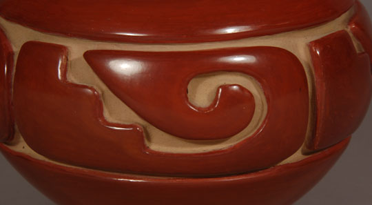 Most collectors are aware that Jennie Trammel made fewer pottery items than any of the other daughters of Margaret Tafoya.  She had a full-time job away from the pueblo and had little time for making pottery.  Interestingly, she was absolutely a phenomenal potter and produced the most beautiful red carved wares of the 20th century.  This red bowl is of the quality collectors expected of her.  It was beautifully formed and expertly carved.  The deep red slip was burnished to perfection.  Provenance:  From the home of the artist.  When Trammel passed away in 2010, her house was locked up and only recently have her daughters begun to clean it out.  There were several finished pottery vessels and two unfinished ones.  This is one of the bowls from her home. 