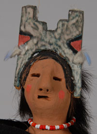 Following an accident in 1948, when a hit-and-run driver ran over him, Manuel lost one leg to amputation. His wife, Vicenta, encouraged him to get back into arts and crafts while he recuperated. He and Vicenta started making pottery together. He would make figurines of pueblo dancers and she would paint them and even make clothing for them. They continued this collaborative effort throughout the remainder of his life.  He is given credit for making the first Native American-made pottery nativity set.  This figurine is of a Pueblo woman dressed in traditional dress and wearing a tableta, apparently meant to be a figure during a plaza dance.  Condition:  The figurine is in original excellent condition.  It is not signed but there is no doubt that it was made by Manuel Vigil and dressed by Vicenta Vigil.  Provenance: from the collection of Katherine H. Rust  Recommended Reading:  Nacimientos by Guy and Doris Monthan 