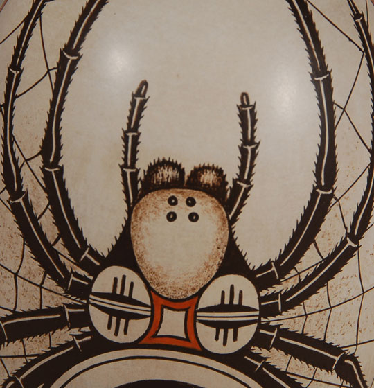 This most unusual jar by Burel Naha is tall and cylindrical and covered with two massive spiders and webs, both on front and back.  I have not seen a design of this nature by him before.  He is the son of Helen Naha (Feather Woman) and brother of Rainy Naha and Sylvia Naha.  Burel and his sisters continued the tradition of their famous mother in producing pottery of the finest quality and with superb design creations.  Condition:  the jar is new and in original excellent condition  Provenance:  recently from the artist  Recommended Reading: Hopi-Tewa Pottery 500 Artist Biographies by Gregory Schaaf 