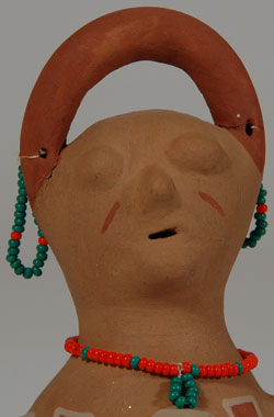 This effigy vessel, made by Carol Sandoval of Ohkay Owingeh Pueblo, is of the style of the Mojave effigy vessels, but is clearly made from Ohkay Owingeh Pueblo clay.  Sandoval is listed as an artist of clay and beadwork so perhaps this was her way to use beadwork with a pottery item.  Condition: original condition Provenance: from the collection of Katherine H. Rust 