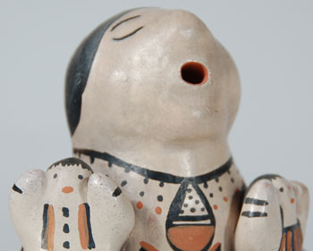 When we organized our first storyteller exhibit at Adobe Gallery in Albuquerque in 1979, there were only five potters making these figurines—Helen Cordero, Dorothy Trujillo, Mary Frances Herrera, Seferina Ortiz, and Rita Lewis. Sadly, today, all of these potters are deceased.   Rita, the daughter of famous potter Ascencion Banada, married Ivan Lewis, son of famous potter Lucy Lewis. Together they started making bowls and animal figurines around 1971, and storyteller figurines around 1973. Following the death of Ivan, Rita continued making storyteller figurines alone. She passed away in 1991.  Rita’s potteries have always been made in true traditional fashion, using Cochiti clay, slip, and vegetal paints and firing the pieces outdoors.  In this figurine, there are two children clinging to the front of the adult figure and one clinging to the back.   It is traditional in every sense—clay, paint, and firing.   Condition: it is in excellent condition and is signed by the artisan.  Provenance:  from an Albuquerque pottery collector  Recommended Reading:  The Pueblo Storyteller by Barbara Babcock 