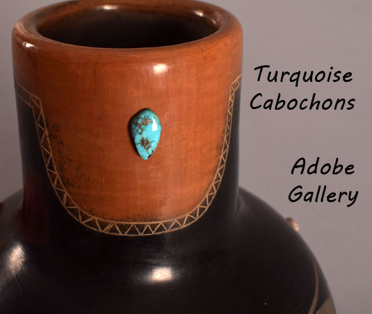 There are two turquoise cabochons located in the sienna section. 
