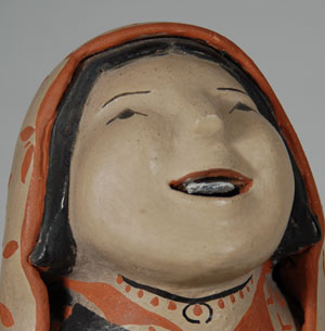 Ada Suina has always been recognized as one of the premier figurine potters at Cochiti. Her storyteller figurines, such as this one, have strong, chiseled faces and happy expressions. She still uses all natural materials and fires the figurines outdoors in the traditional manner.    Ada has recently resumed making pottery figurines following the death of her husband a few years ago. She relied so much on his help in digging the clay and working it to a point where she could form the figurines. Now she has to do everything by herself, therefore it is taking significantly more time to complete a piece.  This storyteller figurine is an older one, probably 20 years old or more, and was made when her husband helped.  Condition:  appears to be in original condition  Provenance: from a gentleman in Albuquerque  Recommended Reading: The Pueblo Storyteller: Development of a Figurative Ceramic Tradition by Barbara Babcock, et al. 