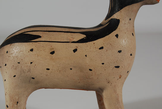 Cochiti Pueblo has a long history of producing figurative pottery. It reached its prime in the last quarter of the 19th century and the first quarter of the 20th century. Popular figurative items were animals, birds, and human forms. This deer is one of the most interesting and best constructed figurines we have had from Cochiti in some time. It is probably early 20th century and is not signed by a potter, which is too bad as the artist should have received credit for such a marvelous piece. There is no damage to the figurine at all. It is in excellent condition.