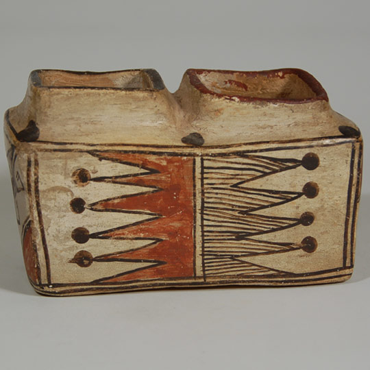 It has  remained a mystery as to the use of these rectangular pottery boxes but it is generally thought there might have been a ceremonial purpose, perhaps for use in kiva ceremonies.  The jar has been identified to circa 1880 by Francis Harlow.   The two chambers of the box are divided by a wall so each chamber serves an independent purpose.  On one side of the wall of the vessel, a red rim coordinates with a red wall design while a black rim coordinates with a black wall design.  On the opposite side of the vessel, a red rim coordinates with a black design and a black rim coordinates with a red design.  The designs on the ends of the vessel are the same.  Six black dots rest on the shoulder of the box and each of the wall designs has black dots capping the triangular design.   Condition: excellent condition. Provenance:  published in the book Modern Pueblo Pottery by Francis Harlow, p 93.  Harlow sold the box to pottery collector Larry Frank who eventually sold it in 2000 to Dr. Allan Cooke, co-author of the book Canvas of Clay: Seven Centuries of Hopi Ceramic Art, from whose collection it is now available. Recommended Reading:  Canvas of Clay: Seven Centuries of Hopi Ceramic Art by Edwin L. Wade and Allan R. Cooke