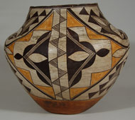 This Acoma olla dates to circa 1940s, and is a superb example of a potter's art. As all traditional pottery of that time period, this olla was formed of native clay with ground pottery shard temper, rag-wiped white slip, red neck interior, and red-slipped underbody with concave base, typical of Acoma pottery.   The high point of maximum diameter, design elements, execution and a shorter neck are indicative of vessels of this time period. The artist chose not to divide the design field into distinct areas separated by division lines; rather, she chose to use the full field to express a single artistic concept.   The rim top and dual framing lines are worked in black paint from a mineral source, which is really dark brown, and are without ceremonial breaks. The fine line and geometric/curvilinear elements are mineral black on rag-wiped white slip, with additional embellishments in typical orange.   There are two main elements of design incorporating the full extent of the jar. One element, on opposing sides of the jar, is a large diamond from rim to lower framing line and from mid-body extending to the adjacent design elements, which, also on opposing sides, are comprised of absolutely exquisite all-black triangles, fine lines, and curvilinear elements.  The diamond elements are split down their centers with a band of fine-line triangles alternating left and right.  Within the triangles to the left and right of this split are strong black elements and orange triangles.   The all black-on-white sections of the design are graceful in their emphasis on the four long curving lines of solid black with appended black triangles and fine line cloud-like elements.  Overall, the jar is beautifully decorated in any position it is viewed.  The painting is evidence of an outstanding potter.   Condition:  The integrity of the vessel is excellent. There is a slope to the upper rim of the jar but that is the manner in which the potter constructed the vessel. Provenance: from the estate of Reggie Sawyer, the Hanging Tree Gallery, Albuquerque Recommended Reading: The Pottery of Acoma Pueblo by Lanmon and Harlow