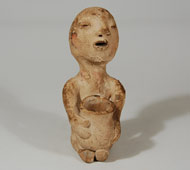 The origin of Tesuque Rain Gods is still somewhat in question. They may be an indigenous development out of a more general Tewa tradition. Before the emergence of the figurine as we know it today, there existed figurines closely related to Kokopelli, the humpbacked, phallic flute player. These early figurines displayed sexual characteristics of male and female genders. A strong similarity exists between these ancestral Rain God figurines and the late 19th century ones. The sexual characteristics disappeared rapidly once the figurines became commercial products.   Their entry into the commercial realm was due to a Santa Fe merchant named Jake Gold who offered Tesuque potters ten cents for each figurine. The potters removed the sexual characteristics from the dolls (probably at the request of Gold) and placed a pot in the lap or on the head. Thus we have the Rain God, as we know it today.   This fine example of a Tesuque Rain God, which probably dates to circa 1890s, originally had paint on his cheeks but most of that is worn away.  It appears that the figurine might have had a short beard on his chin but it is not clearly evident that this is so.    Condition: the right foot is partially broken off but not very evident because it is under the jar.  Provenance: from a young man in Albuquerque who inherited it from his grandfather who grew up on Tesuque Pueblo. Recommended Reading:  The Native American Curio Trade in New Mexico by Jonathan Batkin