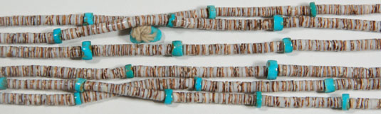 Close up view: This necklace has two additional items usually seen only on necklaces that were made for use by a pueblo person.  One of the items a small turquoise drilled bead.  