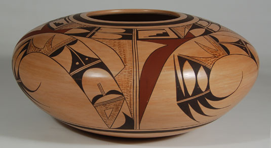 This seed jar is beautifully proportioned and symmetrical.  The design, repeated four times around the jar, is a sweeping and graceful stylized bird of Sikyatki origin.  