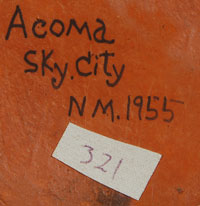 It is signed on the bottom simply:  Acoma Sky City, NM. 1955. 