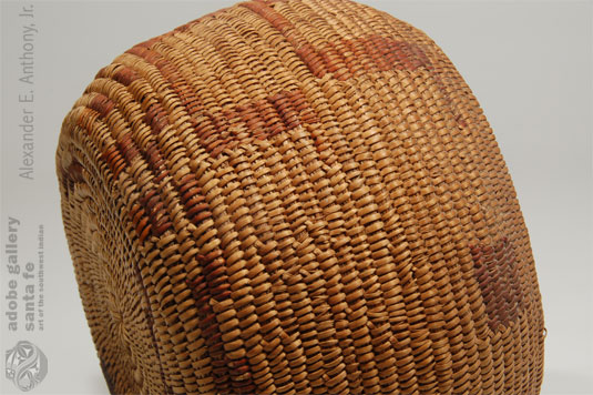 Luiseño coiled baskets have grass foundations and the stitches coil right or clockwise and always slant left when viewed from the finished side.  Materials generally are juncus and sumac. The ends of the sumac are bound under giving the characteristic grasshopper stitching or fag end stitching, sometimes referred to as mission stitch.  This is easily seen in this basket.