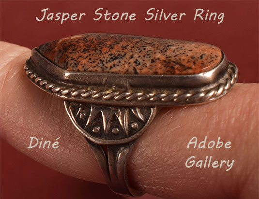 Alternate view of this ring being worn showing side designs in the silver.