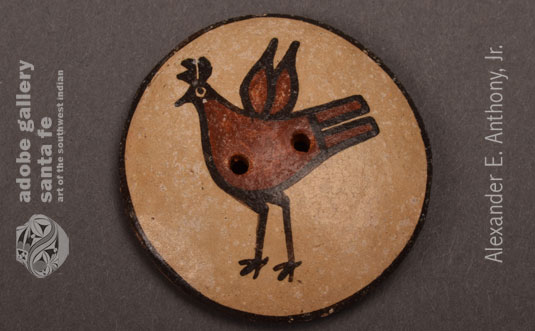 Close up view of one of the Zia Pueblo pottery buttons.