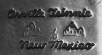 Orville Tsinnie (1943-2017) signs his work with "Orville Tsinnie, New Mexico" along with two stamps of Shiprock.
