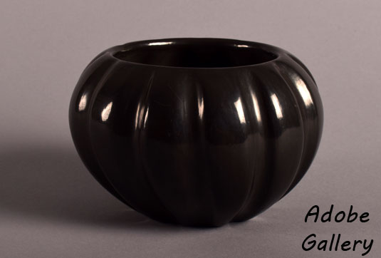 Alternate view of this ribbed black polished pottery vessel.