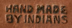 The Garden of the Gods Trading Post was owned by Charles and Esther Strauseback and catered to tourists visiting the nearby Garden of the Gods. The studio specialized in jewelry and decorative items made of silver, copper, aluminum and nickel silver.  Diné (Navajo) and Pueblo artisans were hired  to work there, including San Ildefonso artist Awa Tsireh, who worked at the studio during the 1930s and 1940s. Items made at the studio were stamped with the Tewa Thunderbird and the words “Hand made by Indians.”  The hallmark on this piece has the thunderbird and the inscription. 