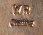 The choler is stamped with the initials WR and Sterling.  None of our reference books lists a silversmith with those initials so we have been unable to state the name of the jeweler of this exquisite jewel of choker.