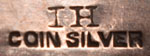 It is stamped IH COIN SILVER,  meaning Indian Handmade which was commonly seen during that time period. 