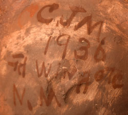 This old Laguna Pueblo pottery jar reveals some of its history to us by information printed on the underside, information painted on with the brown pigment used in the design.  It states CJM 1936 Wingate N.M.  CJM certainly is the potter’s initials and Wingate is where she lived.  Although the potter could have been a resident of Acoma or Laguna, we have chosen Laguna as her tribal affiliation