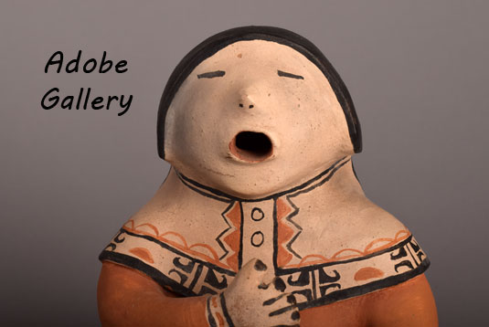 Close up view of the face of this storyteller figurine.