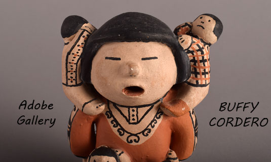 Close up view of the face of this storyteller figurine.
