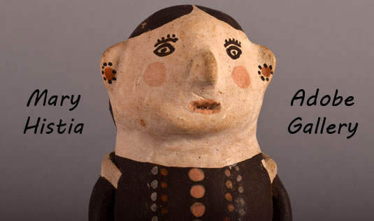 Close up view of the face of this pottery figurine.