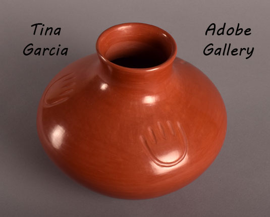 Alternate view of this redware jar showing bear paw imagery.