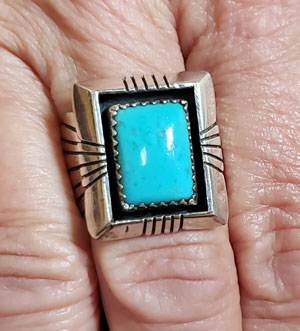 Alternate view of this ring as worn on our Hand Model (Mary). With natural light, it seems even more blue.