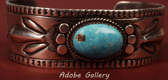 Close up view of the front of this silver and turquoise bracelet.