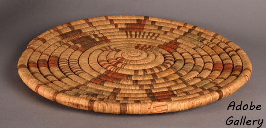 Alternate view of this basketry plaque lying flat.