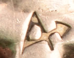 The necklace is stamped with the identity of an artist, but we have been unable to determine the owner of the mark.