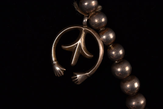 Another similar naja with open hands and a fleur-de-lis without the turquoise cabochon