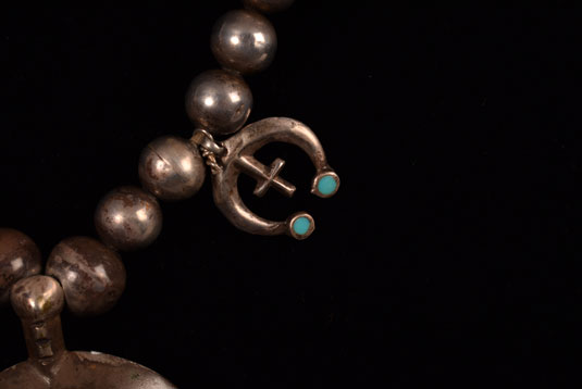 A third even smaller naja with a cross and a pair of turquoise cabochons at the ends