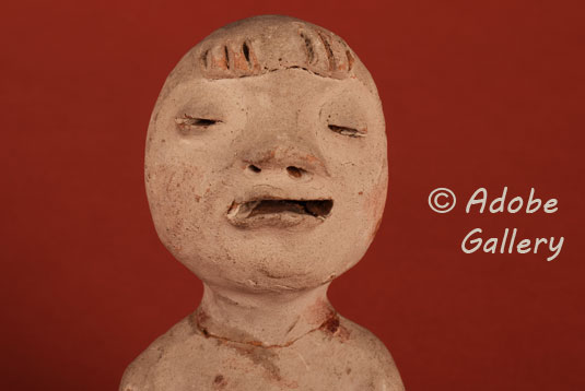 Close up view of the face of this Tesuque Pueblo Rain God Figurine.